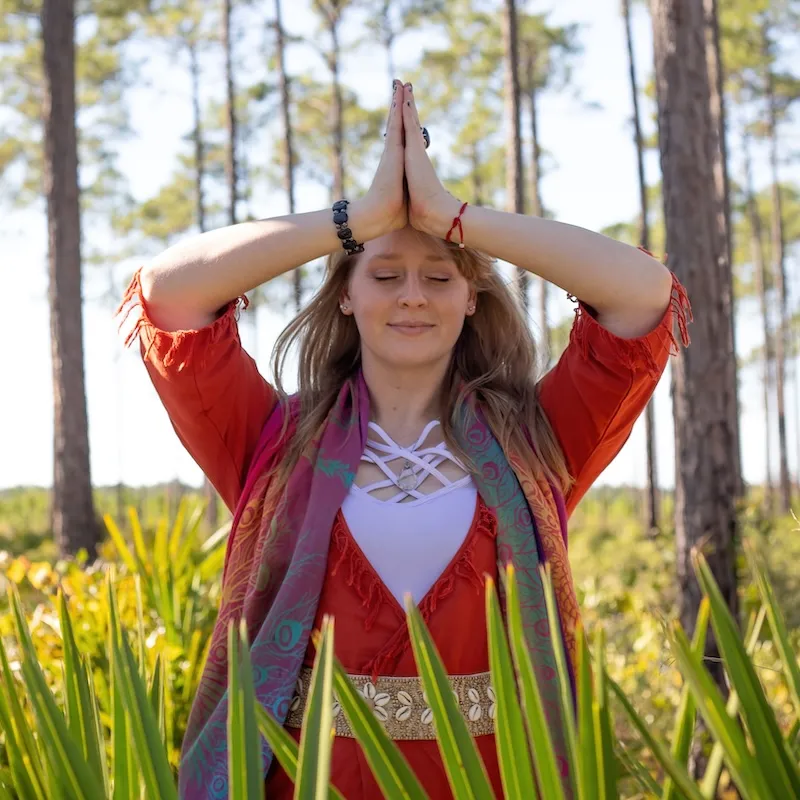 Aarika in a forest preparing for yin yoga session